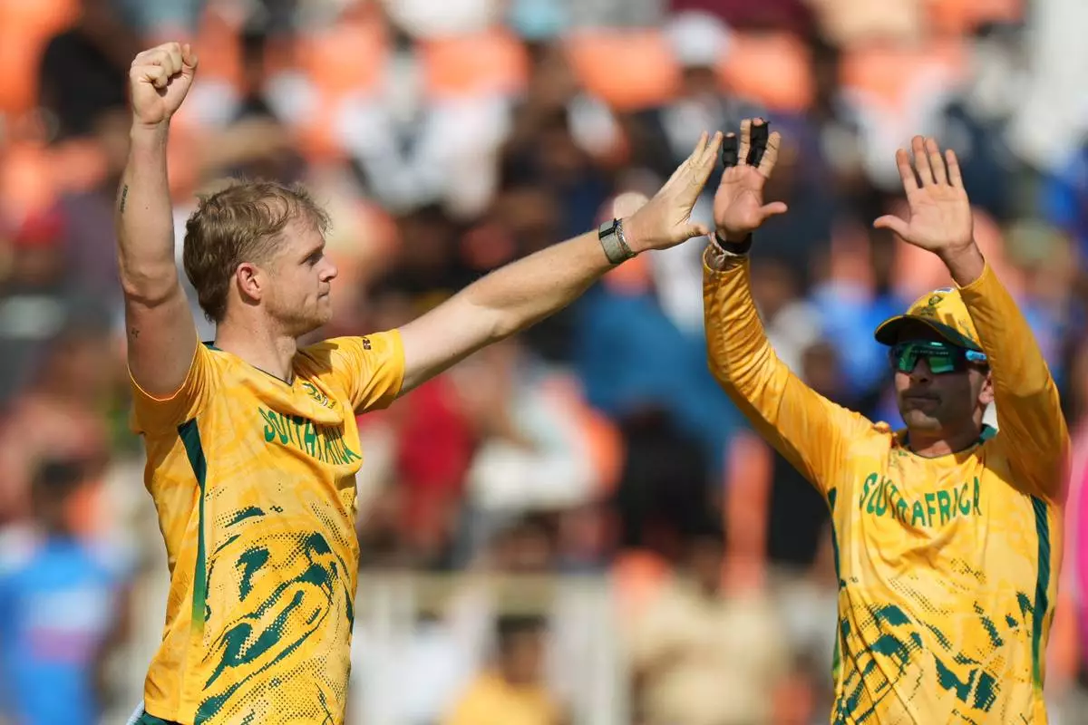 South Africa's Corbin Bosch, left, celebrates with teammate Keshav Maharaj the wicket of West Indies' Matthew Forde during the T20 World Cup cricket match between South Africa and West Indies in Ahmedabad, India, Thursday, Feb. 26, 2026. (AP Photo/Ajit Solanki)