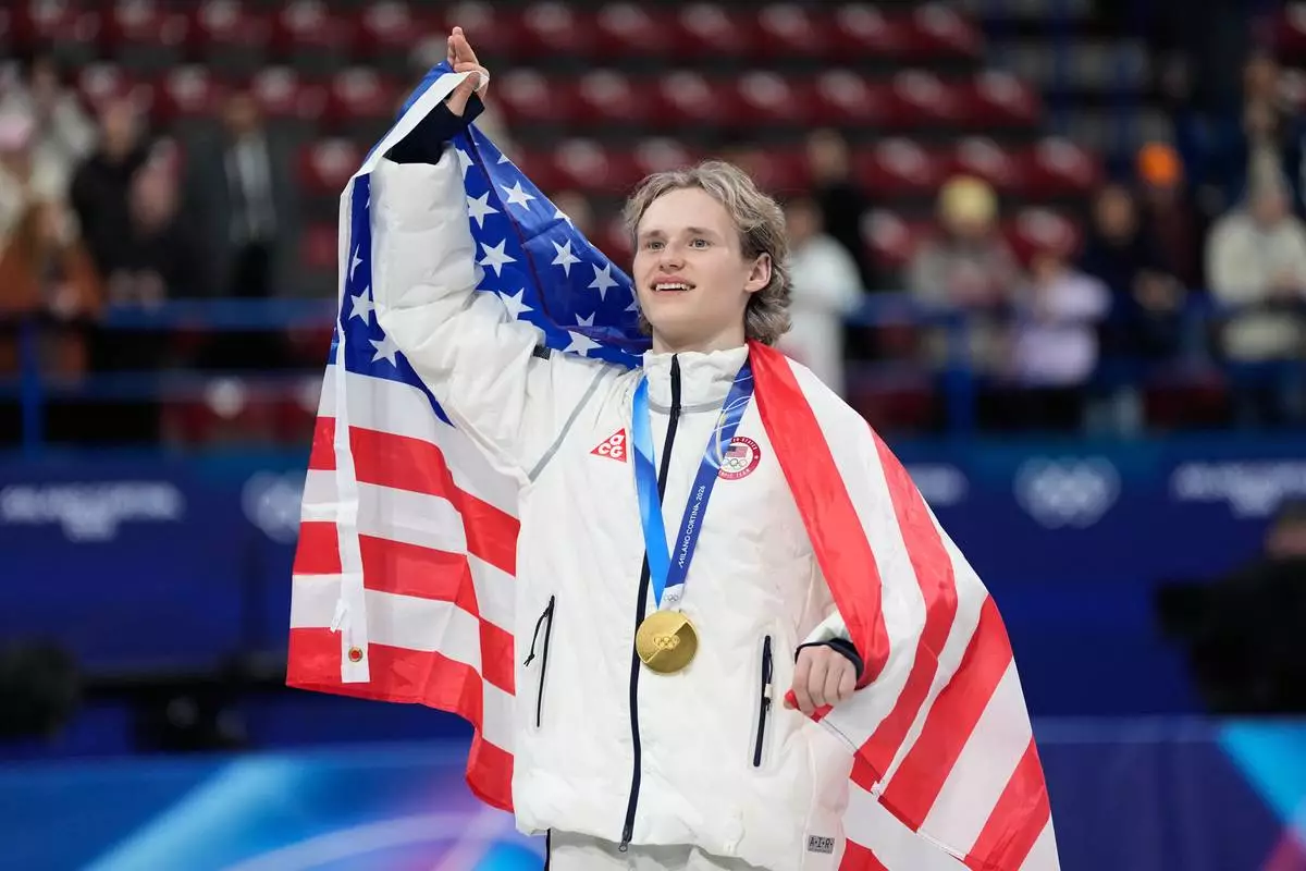 Team USA's Ilia Malinin celebrates with his gold medal after the figure skating team event at the 2026 Winter Olympics, in Milan, Italy, Sunday, Feb. 8, 2026. (AP Photo/Ashley Landis)