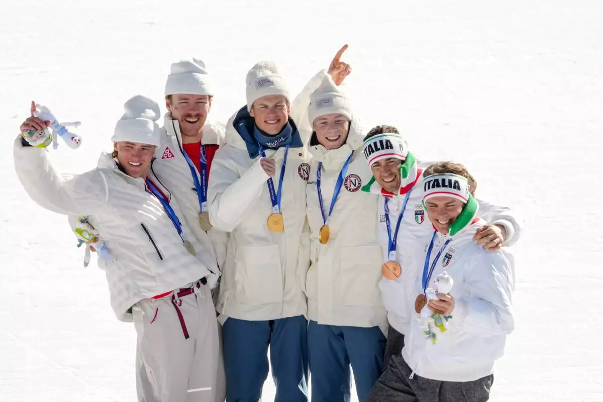 Silver medalists Ben Ogden and Gus Schumacher, of the United States, gold medalist Johannes Hoesflot Klaebo and Einar Hedegart, of Norway, and bronze medalist Elia Barp and Federico Pellegrino, of Italy, pose after the cross-country skiing men's team sprint free at the 2026 Winter Olympics, in Tesero, Italy, Wednesday, Feb. 18, 2026. (AP Photo/Evgeniy Maloletka)