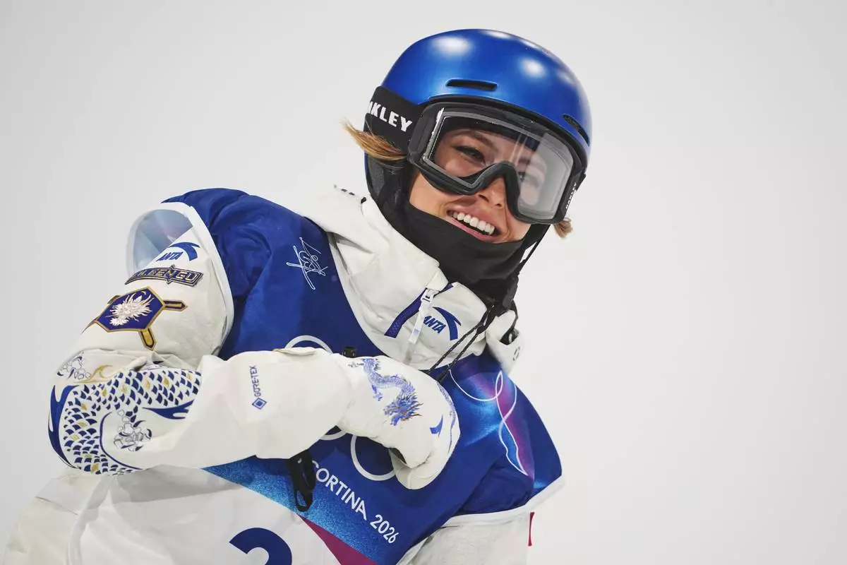 China's Eileen Gu celebrates during the women's freestyle skiing halfpipe qualifications at the 2026 Winter Olympics, in Livigno, Italy, Thursday, Feb. 19, 2026. (AP Photo/Lindsey Wasson)