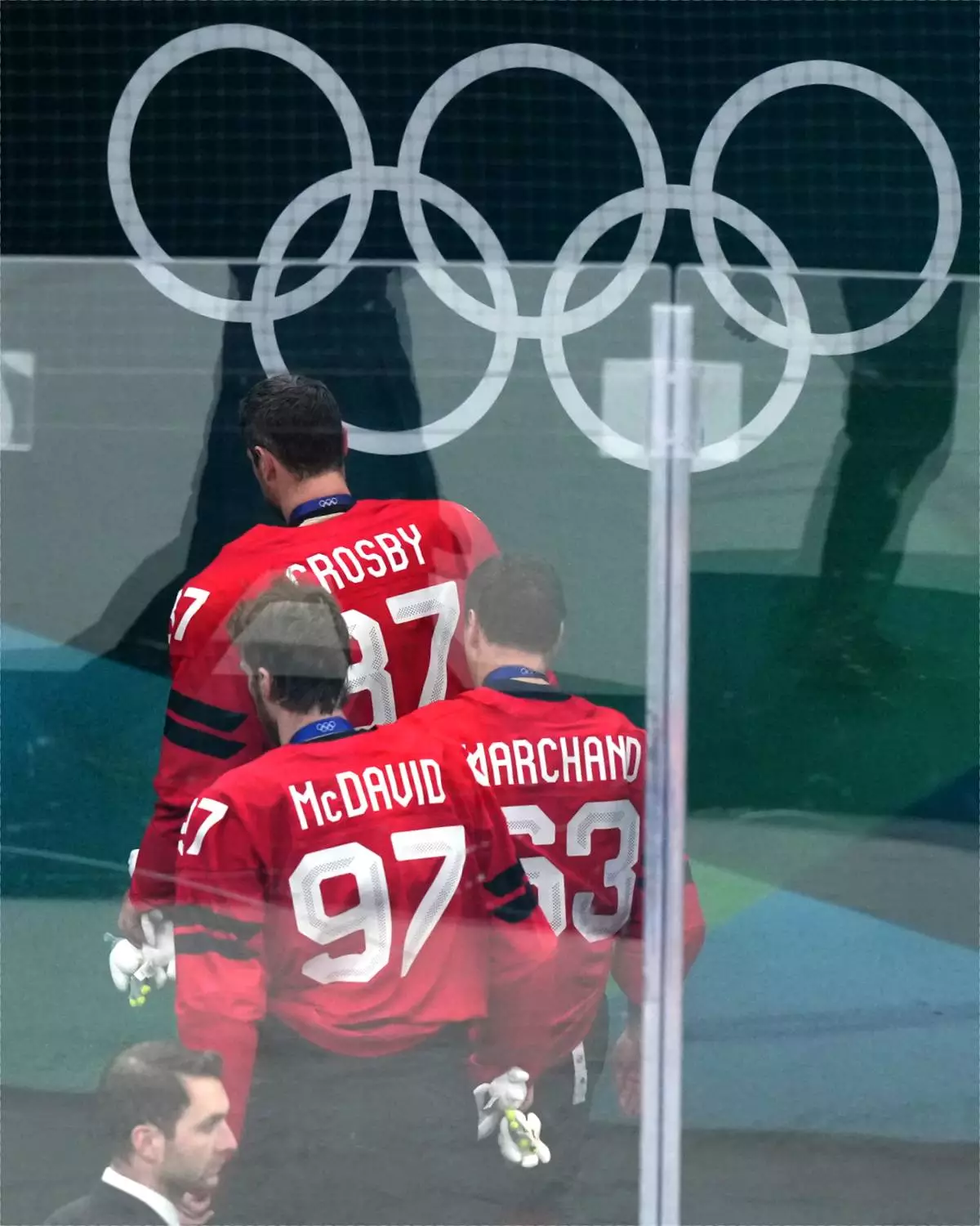 Canada's Sidney Crosby (87), Connor McDavid (97) and Brad Marchand (63) leave the ice following Canada's overtime loss to the United States in the men's ice hockey gold medal game at the 2026 Winter Olympics in Milan, Italy, Sunday, Feb. 22, 2026. (AP Photo/Carolyn Kaster)