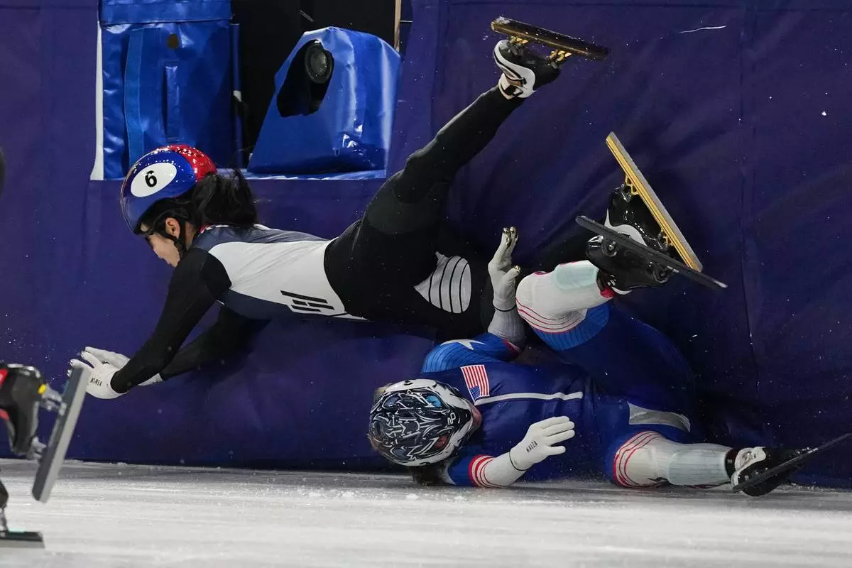 Corinne Stoddard, below, of the United States crashes into Kim Gilli of South Korea while competing in the team mixed relay short track speed skating at the 2026 Winter Olympics, in Milan, Italy, Tuesday, Feb. 10, 2026. (AP Photo/Stephanie Scarbrough)