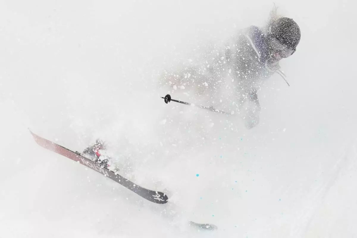 Switzerland's Sarah Hoefflin lands as she competes in the women's freestyle skiing big air qualifications at the 2026 Winter Olympics, in Livigno, Italy, Saturday, Feb. 14, 2026. (AP Photo/Abbie Parr)
