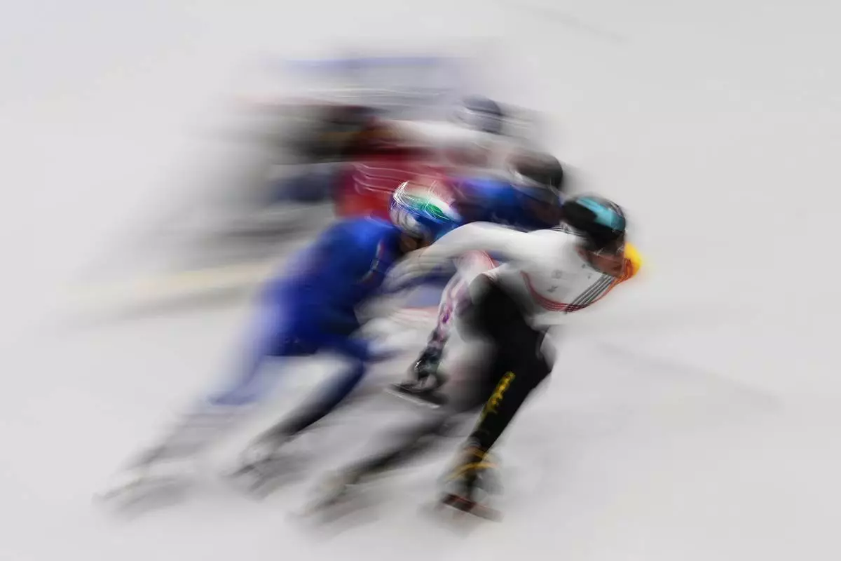 Stijn Desmet of Belgium leads the pack during in the men's 1500 meter short track speed skating at the 2026 Winter Olympics, in Milan, Italy, Saturday, Feb. 14, 2026. (AP Photo/Francisco Seco)