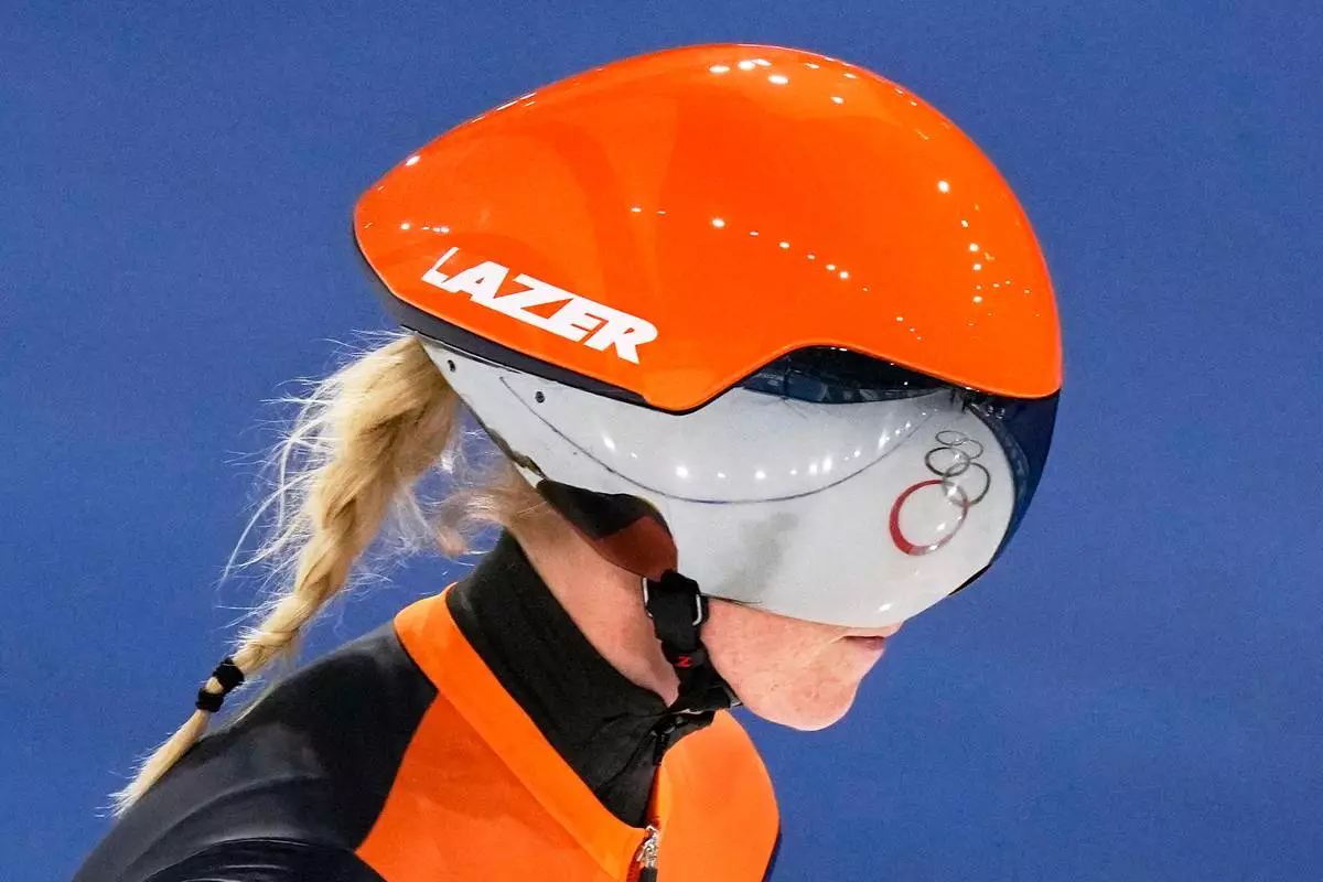 The Olympic Rings are reflected in the helmet of Marijke Groenewoud of the Netherlands after the women's team pursuit quarterfinals speedskating race at the 2026 Winter Olympics, in Milan, Italy, Saturday, Feb. 14, 2026. (AP Photo/Luca Bruno)