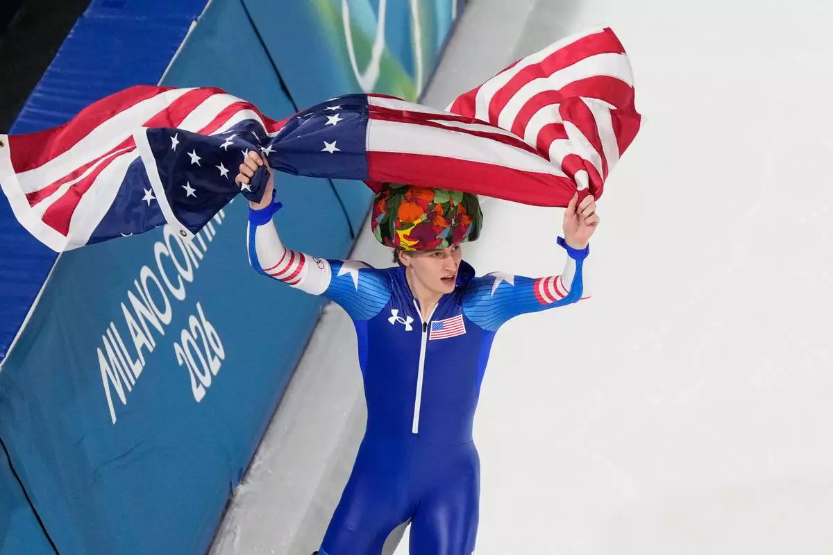 United States' Jordan Stolz celebrates after winning gold and setting a new Olympic record in the men's 500-meters speedskating final at the 2026 Winter Olympics, in Milan, Italy, Saturday, Feb. 14, 2026. (AP Photo/David J. Phillip)