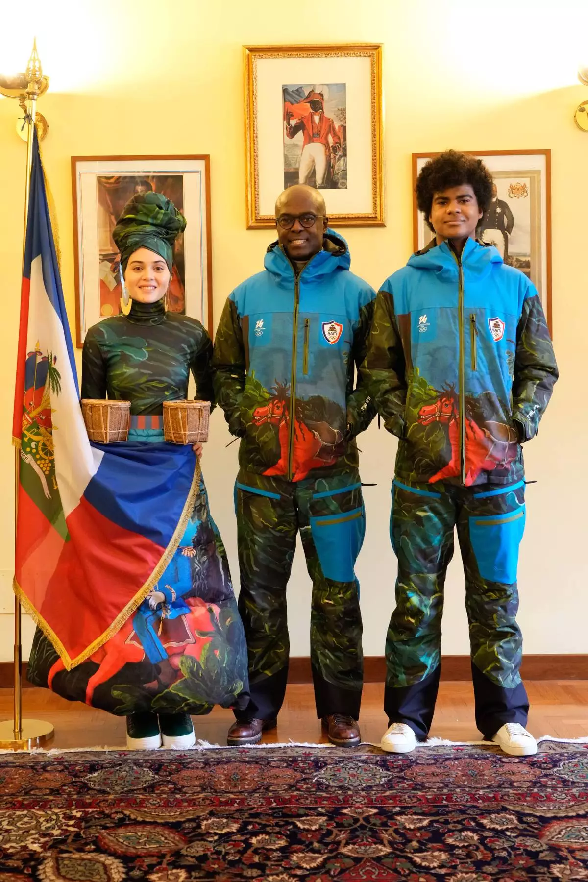 From left, Livia Audain, Haiti's Ambassador to Italy Gandy Thomas, and Megan Thomas pose at the Haitian Embassy in Rome, Saturday, Jan. 31, 2026, with the official uniform for the Haitian national team participating in the 2026 Winter Olympics. (AP Photo/Gregorio Borgia)