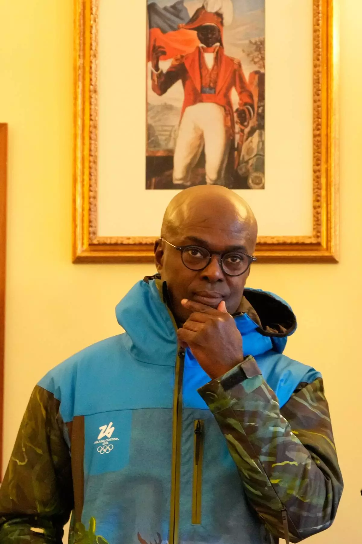 Haiti's Ambassador to Italy, Gandy Thomas, poses at the Haitian Embassy in Rome, Saturday, Jan. 31, 2026, with the official uniform for the Haitian national team participating in the 2026 Winter Olympics. (AP Photo/Gregorio Borgia)