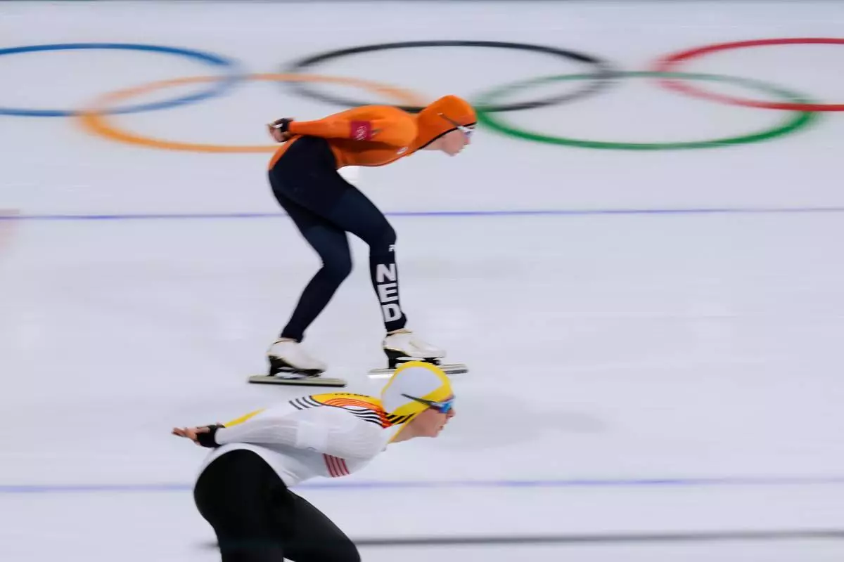 Sandrine Tas of Belgium, bottom, and Merel Conijn of the Netherlands compete in the women's 5,000 meters speedskating race at the 2026 Winter Olympics, in Milan, Italy, Thursday, Feb. 12, 2026. (AP Photo/Luca Bruno)