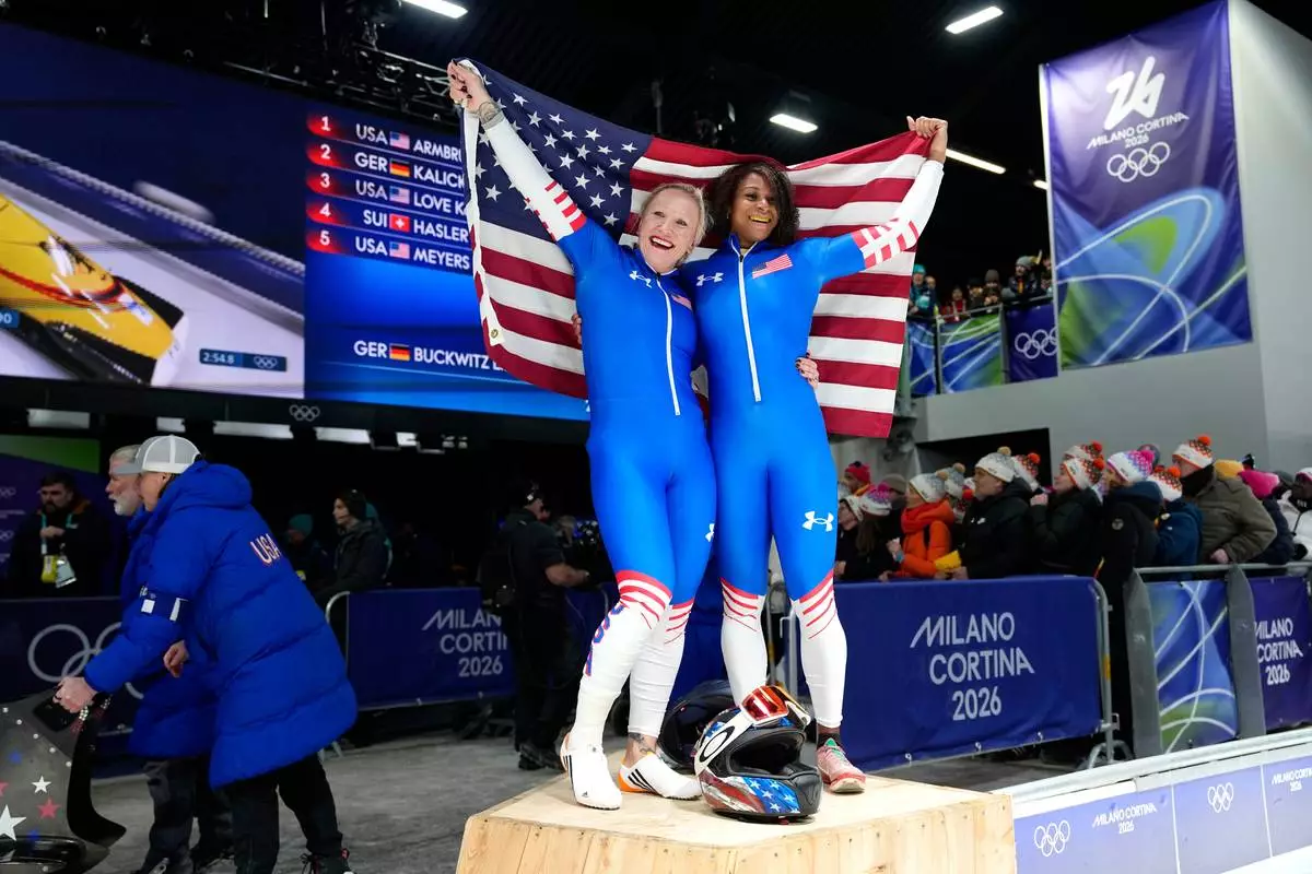 United States' Kaillie Armbruster Humphries, left, and Jasmine Jones arrive at the finish during a two women bobsled run at the 2026 Winter Olympics, in Cortina d'Ampezzo, Italy, Saturday, Feb. 21, 2026. (AP Photo/Alessandra Tarantino)