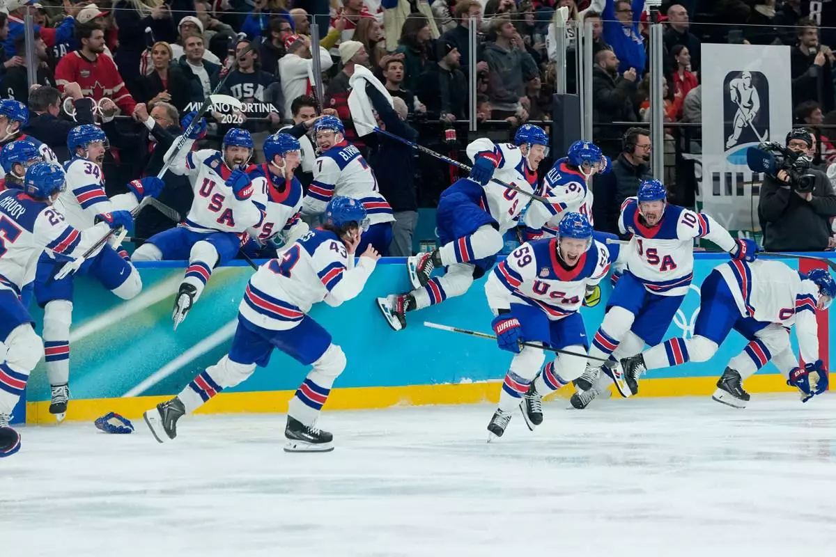 United States celebrate after defeating Canada in a men's ice hockey gold medal game between Canada and the United States at the 2026 Winter Olympics, in Milan, Italy, Sunday, Feb. 22, 2026. (AP Photo/Petr David Josek)