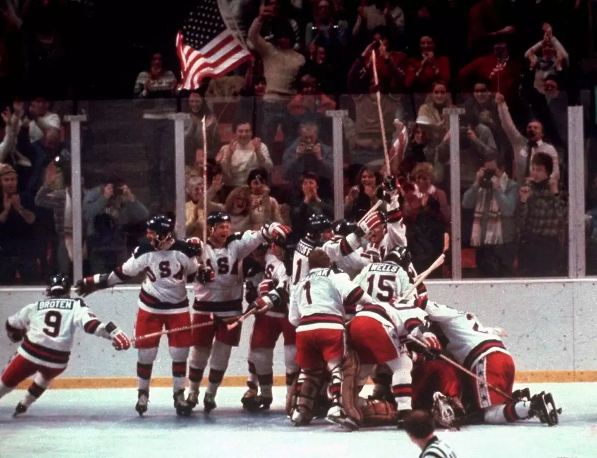 FILE - United States' hockey team pounces on goalie Jim Craig after a 4-3 victory against the Soviet Union in a medal round match at the the 1980 Winter Olympics in Lake Placid, N.Y., Feb. 22, 1980. (AP Photo/File)
