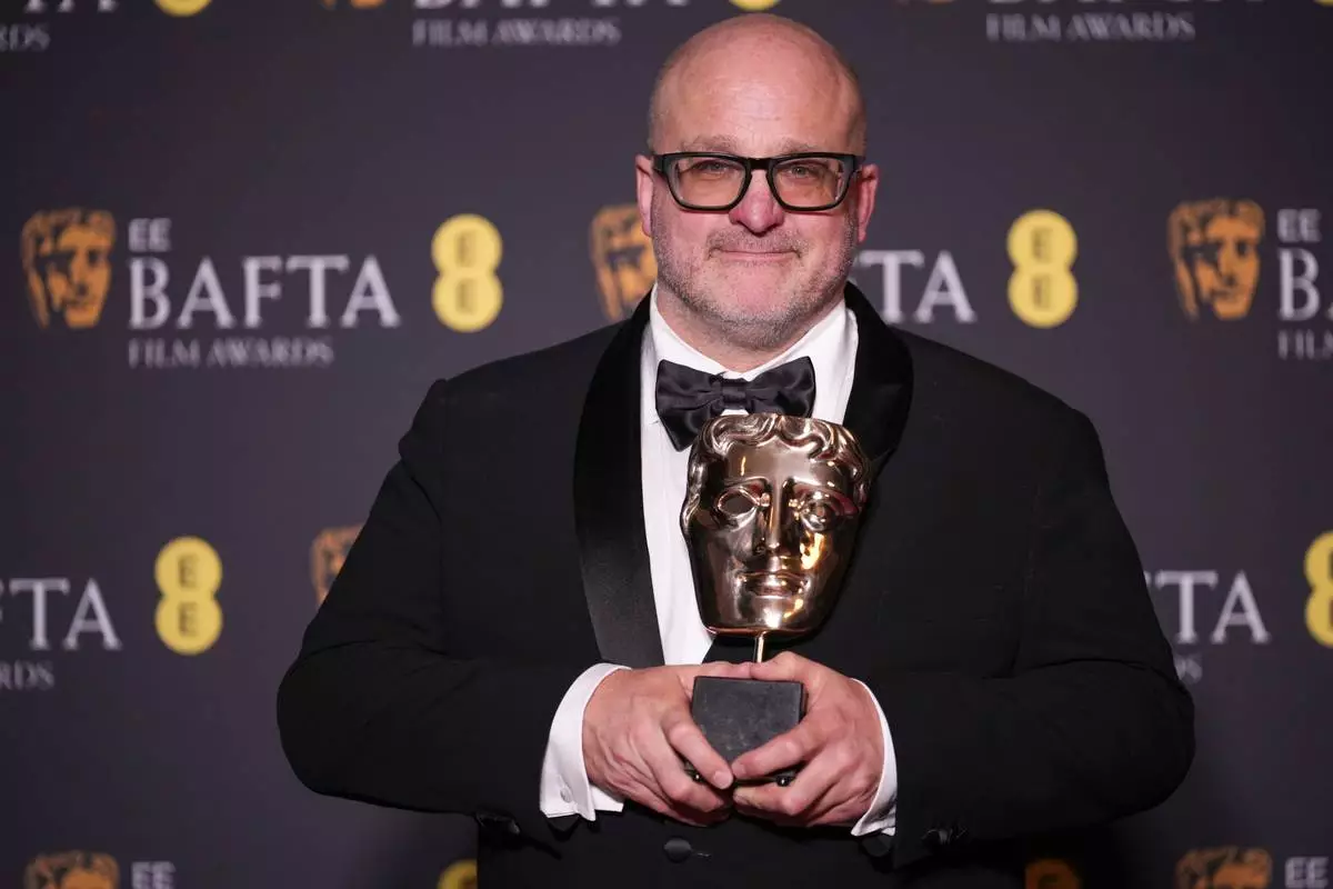 Michael Bauman poses with the award for cinematography for 'One Battle After Another' at the 79th British Academy Film Awards, BAFTA's, in London, Sunday, Feb. 22, 2026. (AP Photo/Alastair Grant)