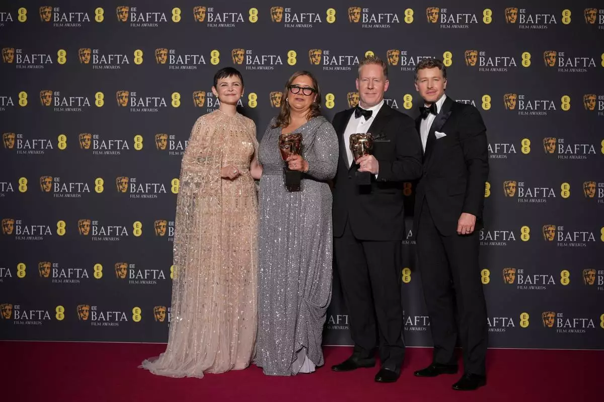 Ginnifer Goodwin, from left, Yvett Merino, Jared Bush, and Josh Dallas pose with the award for animated film for 'Zootopia 2'at the 79th British Academy Film Awards, BAFTA's, in London, Sunday, Feb. 22, 2026. (AP Photo/Alastair Grant)