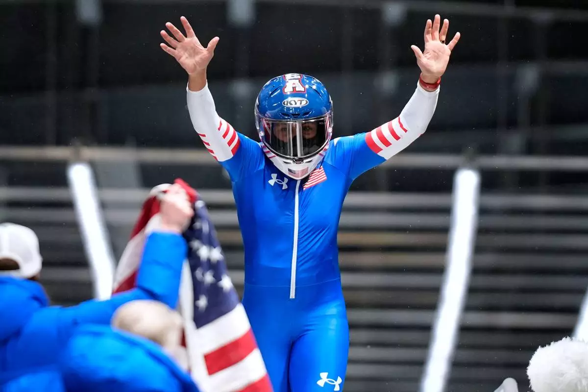 United States' gold medalist Elana Meyers Taylor celebrates at the finish after the women's monobob competition at the 2026 Winter Olympics, in Cortina d'Ampezzo, Italy, Monday, Feb. 16, 2026.(AP Photo/Aijaz Rahi)