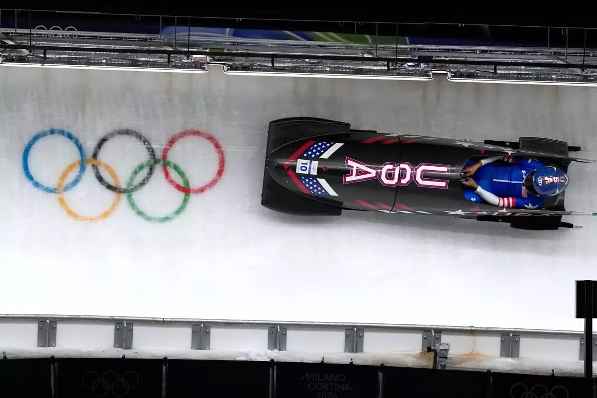 United States' Elana Meyers Taylor slides down the track during a women's monobob run at the 2026 Winter Olympics, in Cortina d'Ampezzo, Italy, Monday, Feb. 16, 2026. (AP Photo/Alessandra Tarantino)