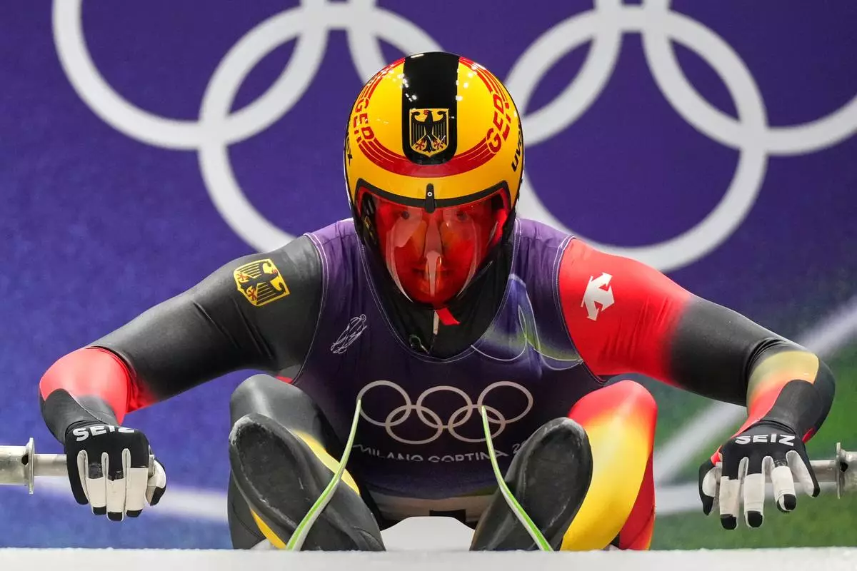 Germany's Max Langenhan prepares for a men's single luge run at the 2026 Winter Olympics, in Cortina d'Ampezzo, Italy, Saturday, Feb. 7, 2026. (AP Photo/Alessandra Tarantino)