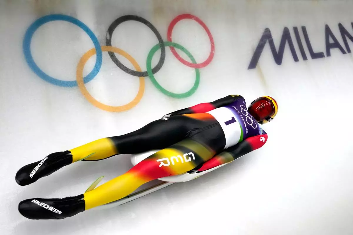Germany's Max Langenhan slides down the track during a men's single luge training session at the 2026 Winter Olympics, in Cortina d'Ampezzo, Italy, Saturday, Feb. 7, 2026. (AP Photo/Aijaz Rahi)