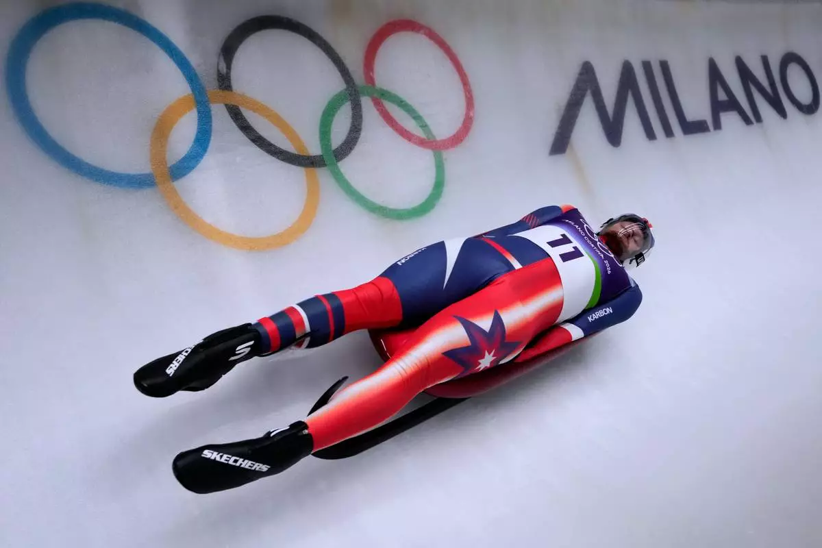 United States' Jonathan Gustafson slides down the track during a men's single luge run at the 2026 Winter Olympics, in Cortina d'Ampezzo, Italy, Saturday, Feb. 7, 2026. (AP Photo/Aijaz Rahi)