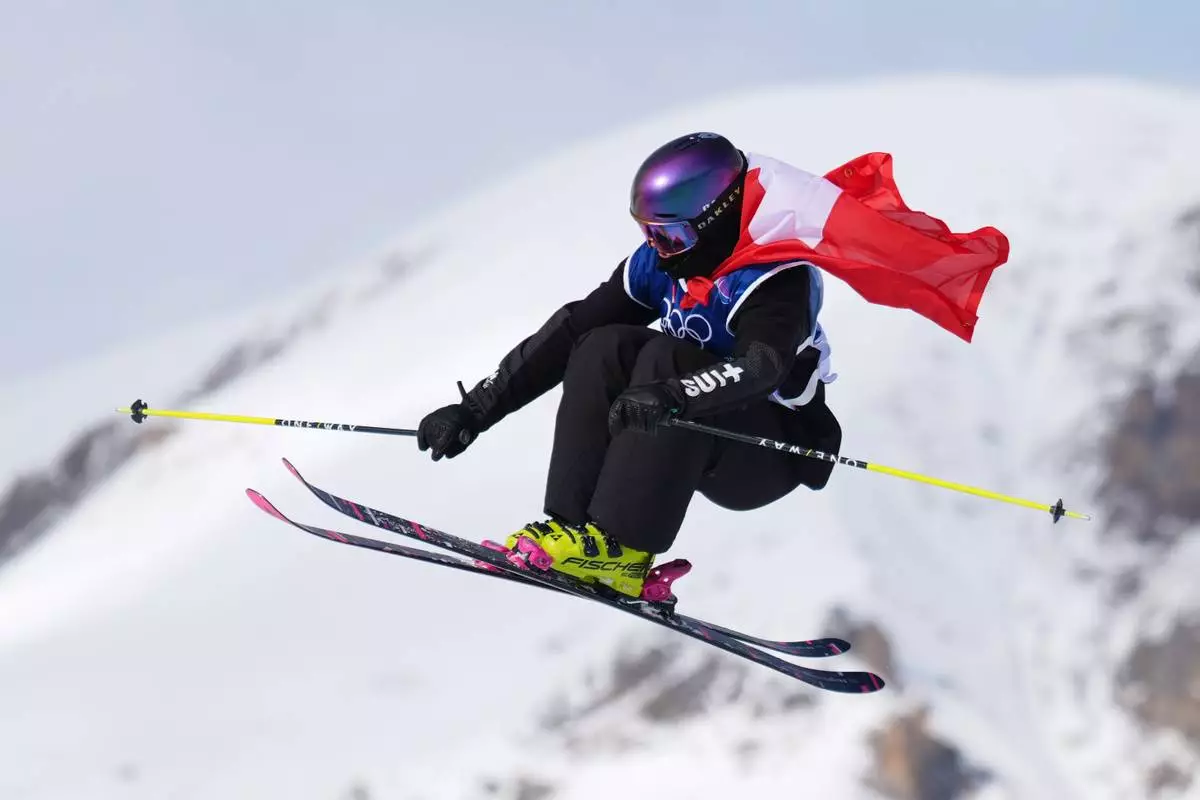 Switzerland's Mathilde Gremaud celebrates her gold medal on her final run in the women's freestyle skiing slopestyle finals at the 2026 Winter Olympics, in Livigno, Italy, Monday, Feb. 9, 2026. (AP Photo/Abbie Parr)