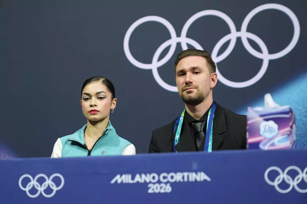 Adeliia Petrosian of Individual Neutral Athletes reacts to her score after competing in the women's figure skating free program at the 2026 Winter Olympics, in Milan, Italy, Thursday, Feb. 19, 2026. (AP Photo/Stephanie Scarbrough)
