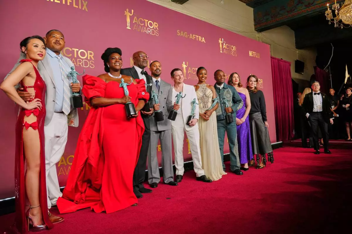 Michael B. Jordan, center, winner of the award for outstanding performance by a male actor, and the cast of "Sinners" pose with award for outstanding performance by a cast in a motion picture during the 32nd Annual Actor Awards on Sunday, March 1, 2026, at the Shrine Auditorium and Expo Hall in Los Angeles. (Photo by Jordan Strauss/Invision/AP)