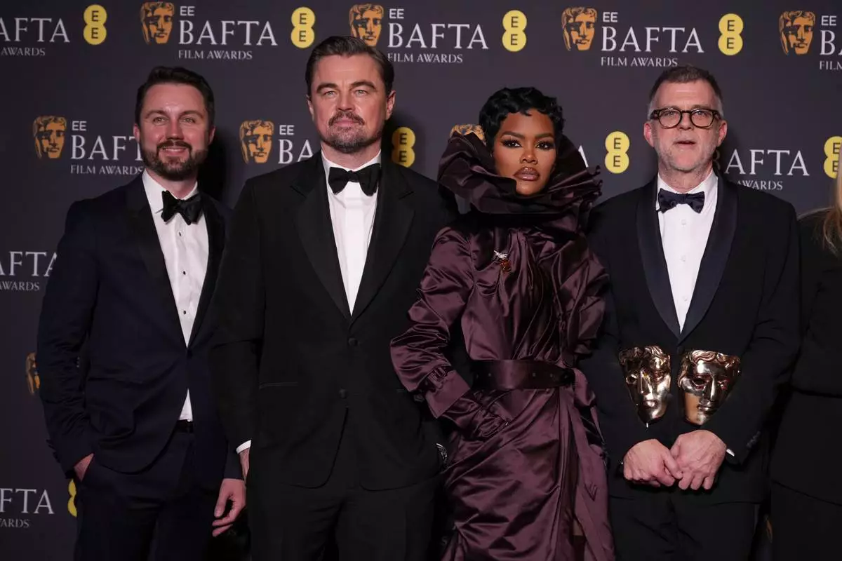 Andy Jurgensen, from left, Leonardo DiCaprio, Teyana Taylor, and Paul Thomas Anderson pose with the awards for best director, cinematography, and adapted screenplay for 'One Battle After Another' at the 79th British Academy Film Awards, BAFTA's, in London, Sunday, Feb. 22, 2026. (AP Photo/Alastair Grant)