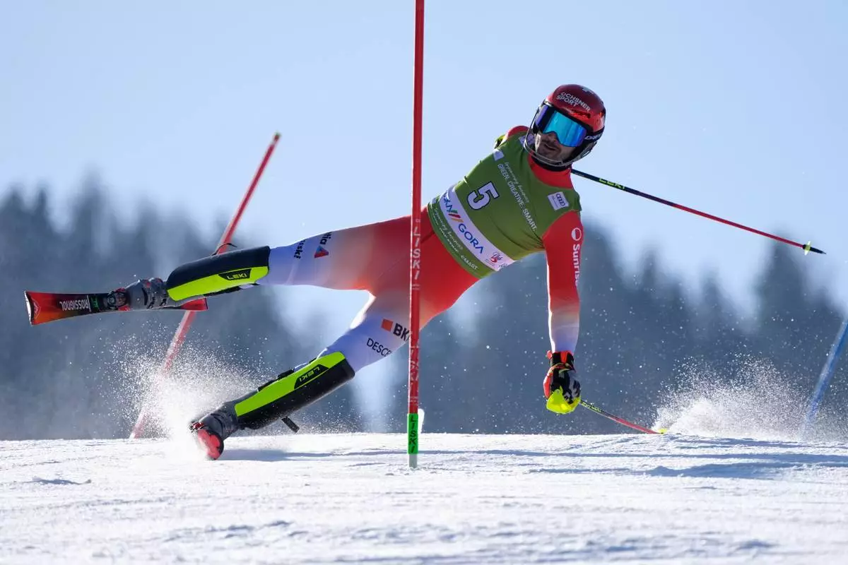 Switzerland's Loic Meillard straddles a pole as he competes in an alpine ski, men's World Cup slalom, in Kranjska Gora, Slovenia, Sunday, March 8, 2026. (AP Photo/Giovanni Auletta)
