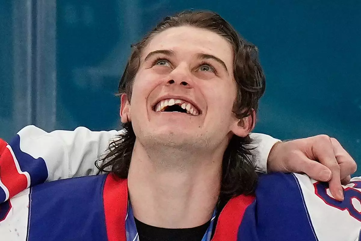 United States' Jack Hughes (86) reacts after receiving his gold medal after the USA defeated Canada in the men's ice hockey gold medal game at the 2026 Winter Olympics, in Milan, Italy, Sunday, Feb. 22, 2026. (AP Photo/Luca Bruno)
