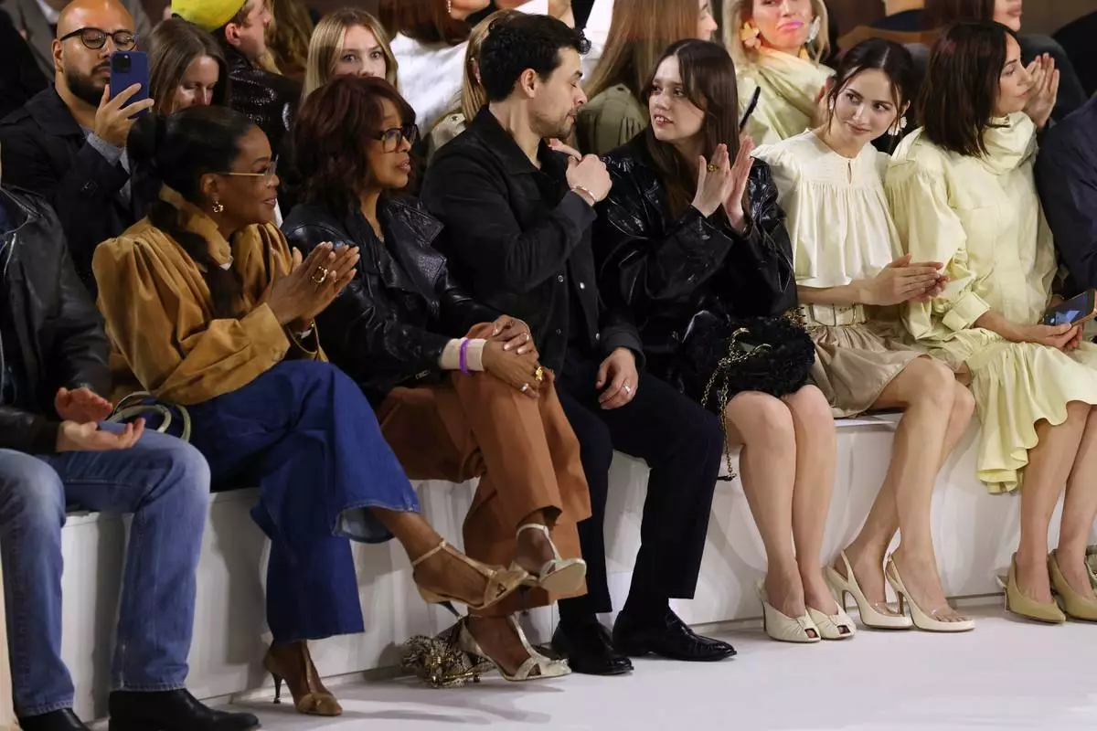 Oprah Winfrey, from left, Gayle King, Adam Long, Aimee Lou Wood and Maude Apatow attend the Chloe Fall/Winter 2026-2027 Women's collection presented in Paris, Thursday, March 5, 2026. (AP Photo/Tom Nicholson)