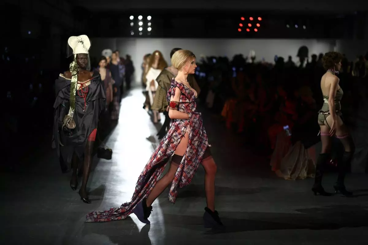 Models wear creations from the Vivienne Westwood Fall/Winter 2026-2027 Women's collection presented in Paris, Saturday, March 7, 2026. (AP Photo/Tom Nicholson)