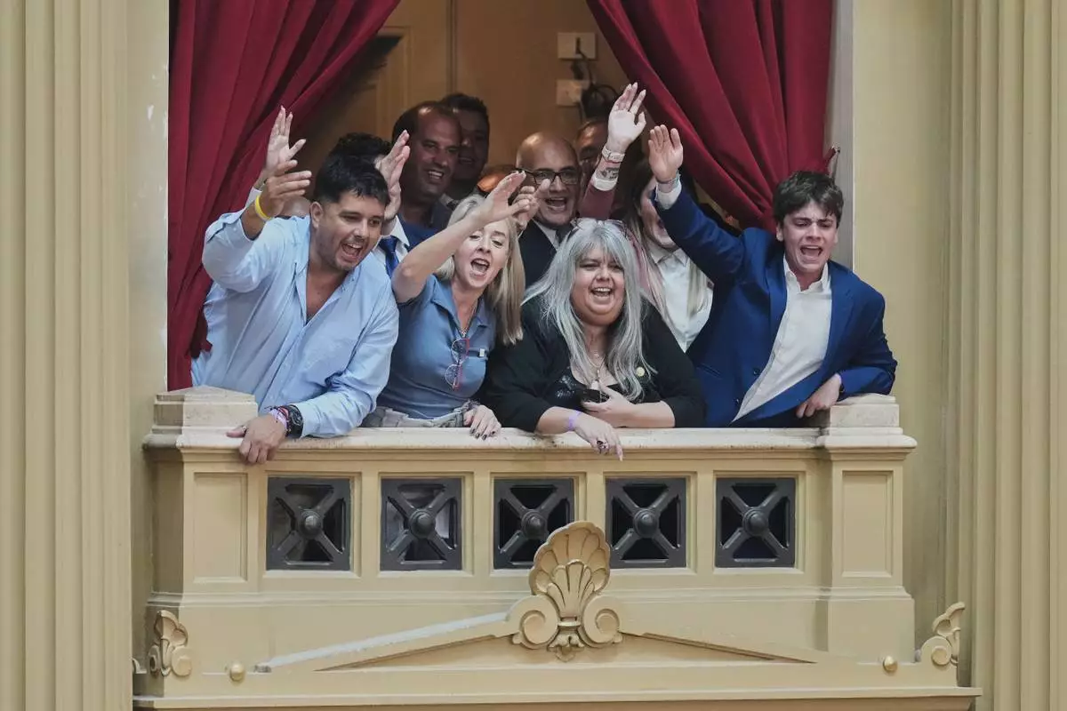 FILE - Attendees react to President Javier Milei's annual State of the Nation address at Congress in Buenos Aires, Argentina, March 1, 2026. (AP Photo/Gustavo Garello, File)