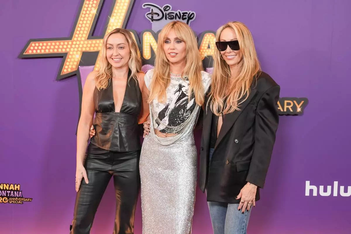 Brandi Cyrus, from left, Miley Cyrus, and Tish Cyrus-Purcell arrive at the premiere of "Hannah Montana 20th Anniversary Special" on Monday, March 23, 2026, at El Capitan Theatre in Los Angeles. (AP Photo/Chris Pizzello)