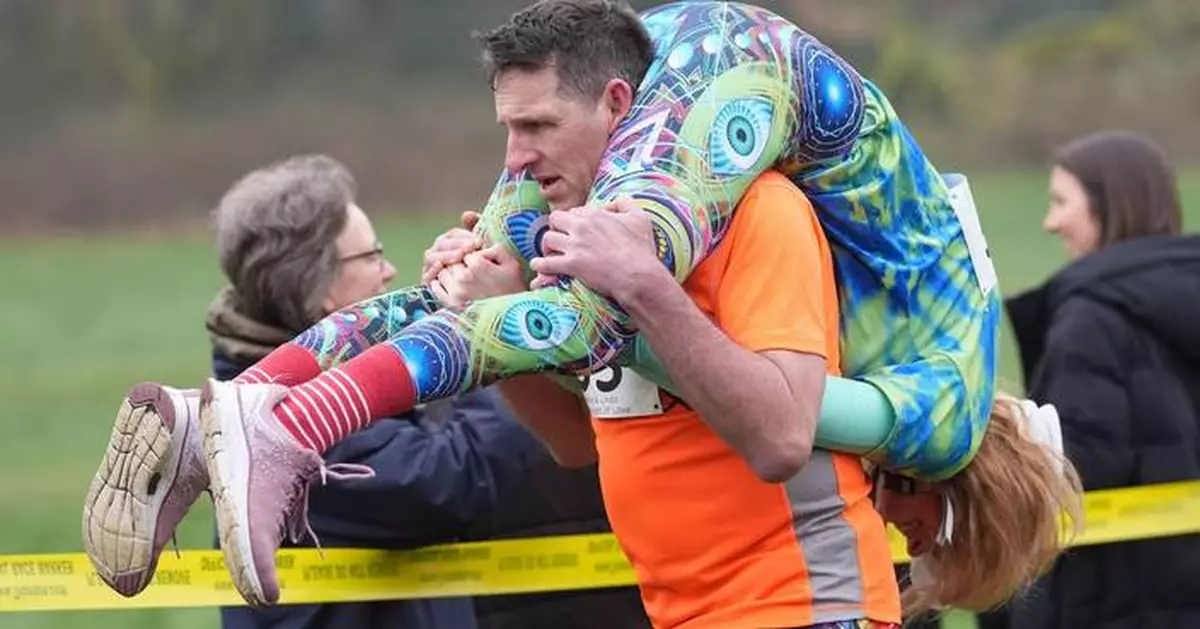 Finnish pair wins a barrel of ale in annual 'wife-carrying' contest in England