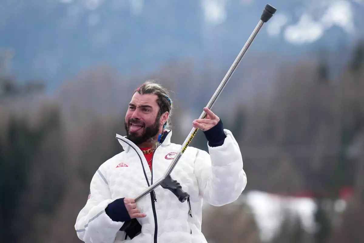 Patrick Halgren, of the United States, celebrates on the podium after winning the silver medal in the alpine skiing men's super-G standing at the 2026 Winter Paralympics, in Cortina d'Ampezzo, Italy, Monday, March 9, 2026. (AP Photo/Emilio Morenatti)