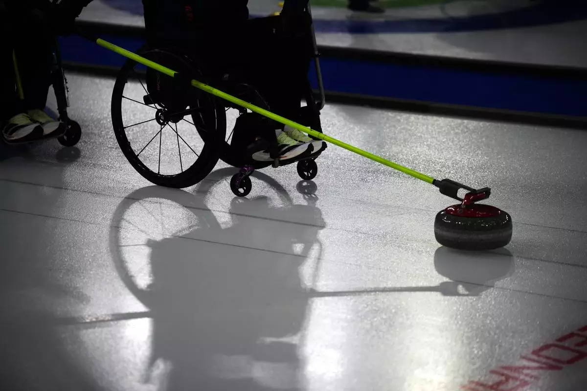 Joanna Butterfield, of Britain, competes against South Korea in a wheelchair curling mixed doubles round robin session at the 2026 Winter Paralympics, in Cortina d'Ampezzo, Italy, Thursday, March 5, 2026. (AP Photo/Emilio Morenatti)