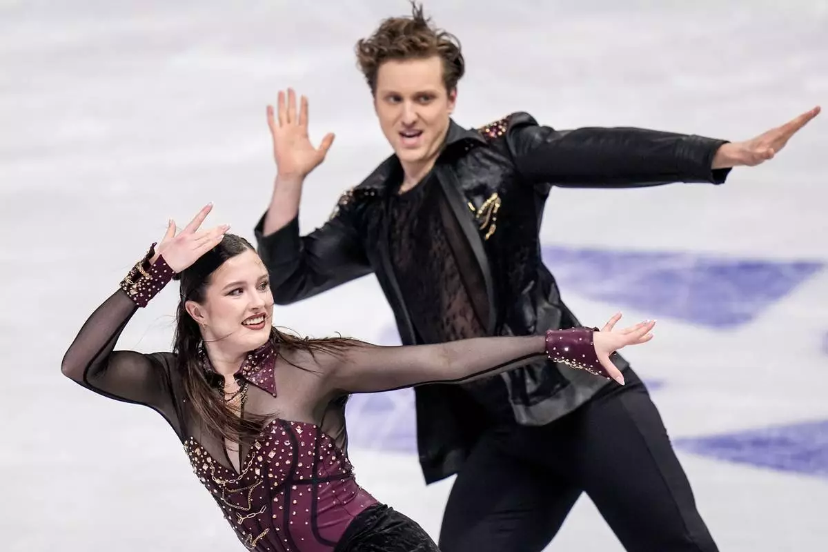 Christina Carreira and Anthony Ponomarenko from the United States perform during the ice dance rhythm dance at the Figure Skating World Championships in Prague, Czech Republic, Friday, March 27, 2026. (AP Photo/Petr David Josek)