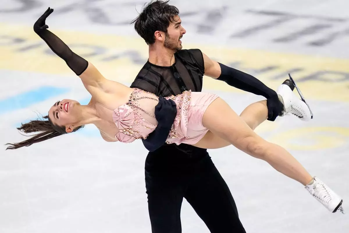 Laurence Fournier Beaudry and Guillaume Cizeron from France perform during the ice dance rhythm dance at the Figure Skating World Championships in Prague, Czech Republic, Friday, March 27, 2026. (AP Photo/Petr David Josek)