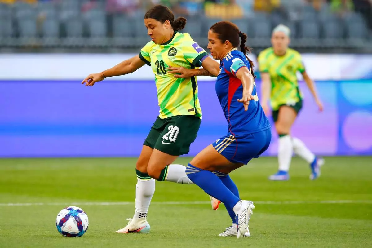 Australia's Sam Kerr, left, and Philippines' Hali Long battle for the ball during the Women's Asia Cup soccer match between Australia and the Philippines in Perth, Australia, Sunday, March 1, 2026. (AP Photo/Gary Day)