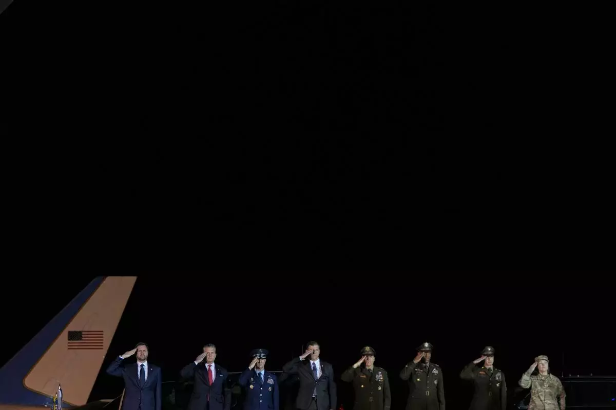 Vice President JD Vance, Defense Secretary Pete Hegseth, Chairman of the Joint Chiefs of Staff Gen. Dan Caine, and other military leaders, salute during a dignified transfer for Sgt. Benjamin N. Pennington, 26, of Glendale, Ky., Monday March 9, 2026, at Dover Air Force Base, Del. (AP Photo/Julia Demaree Nikhinson)