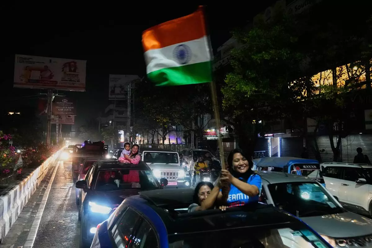 Cricket fans celebrate India's win in the T20 World Cup cricket final match against New Zealand, in Guwahati, India, Sunday, March 8, 2026. (AP Photo/Anupam Nath)