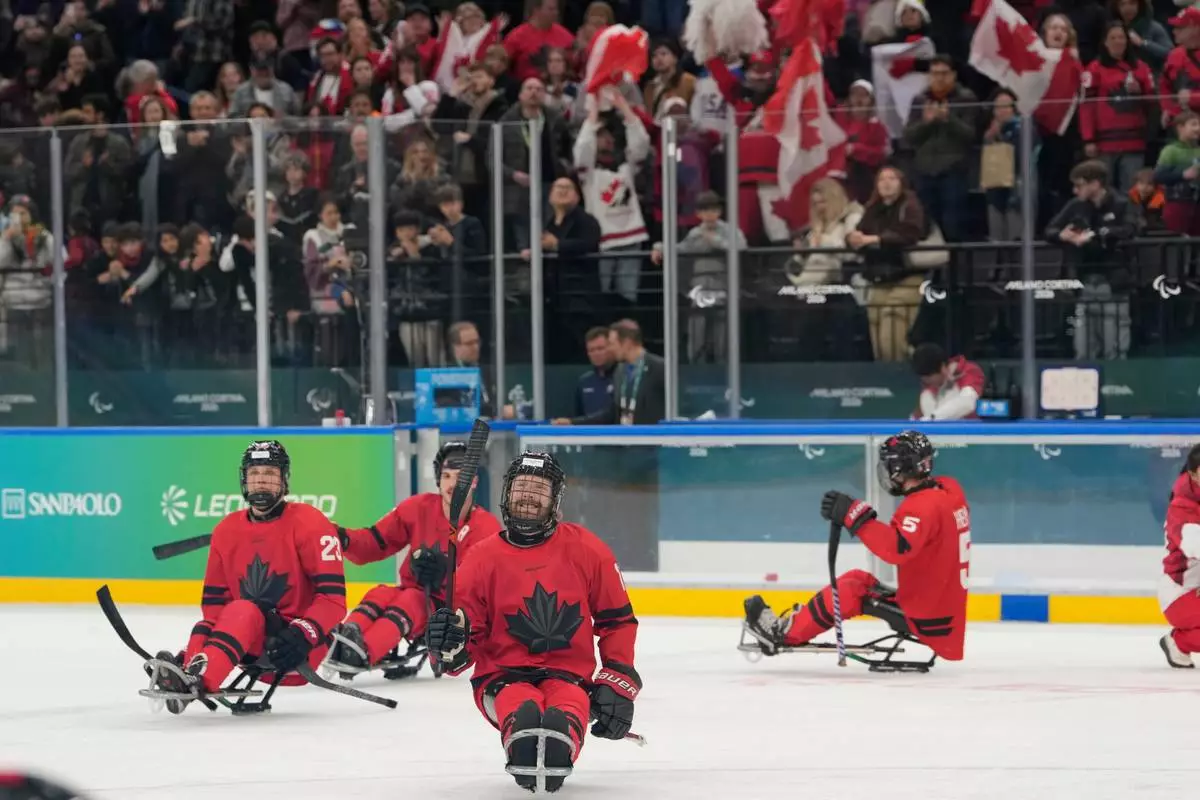 Canada players celebrate after winning a semifinal hockey match between against China at the 2026 Winter Paralympics, in Milan, Italy, Friday, March 13, 2026. (AP Photo/Luca Bruno)