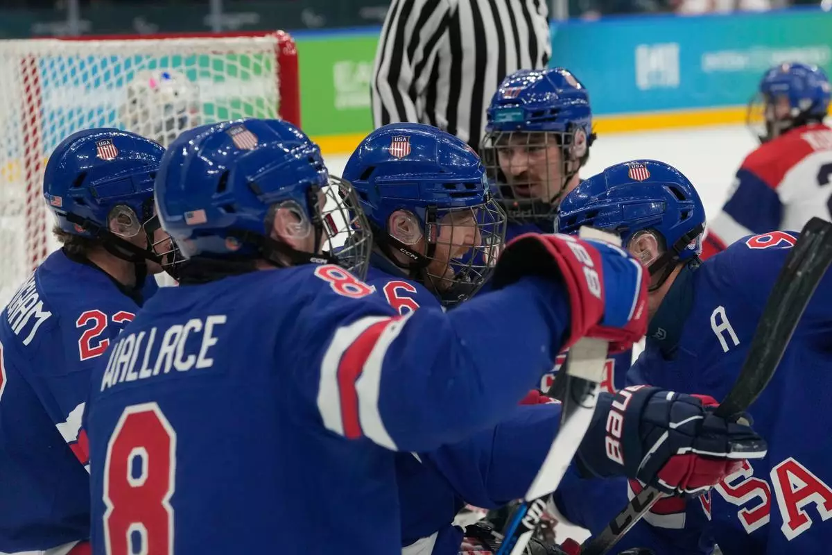 United State's Declan Farmer, center, celebrates with his teammates after scoring his side's first goal during a semifinal hockey match between United States and Czech Republic at the 2026 Winter Paralympics, in Milan, Italy, Friday, March 13, 2026. (AP Photo/Luca Bruno)