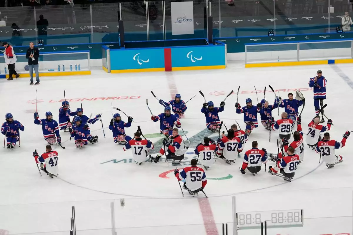 United States players celebrate after winning a semifinal hockey match against Czech Republic at the 2026 Winter Paralympics, in Milan, Italy, Friday, March 13, 2026. (AP Photo/Luca Bruno)