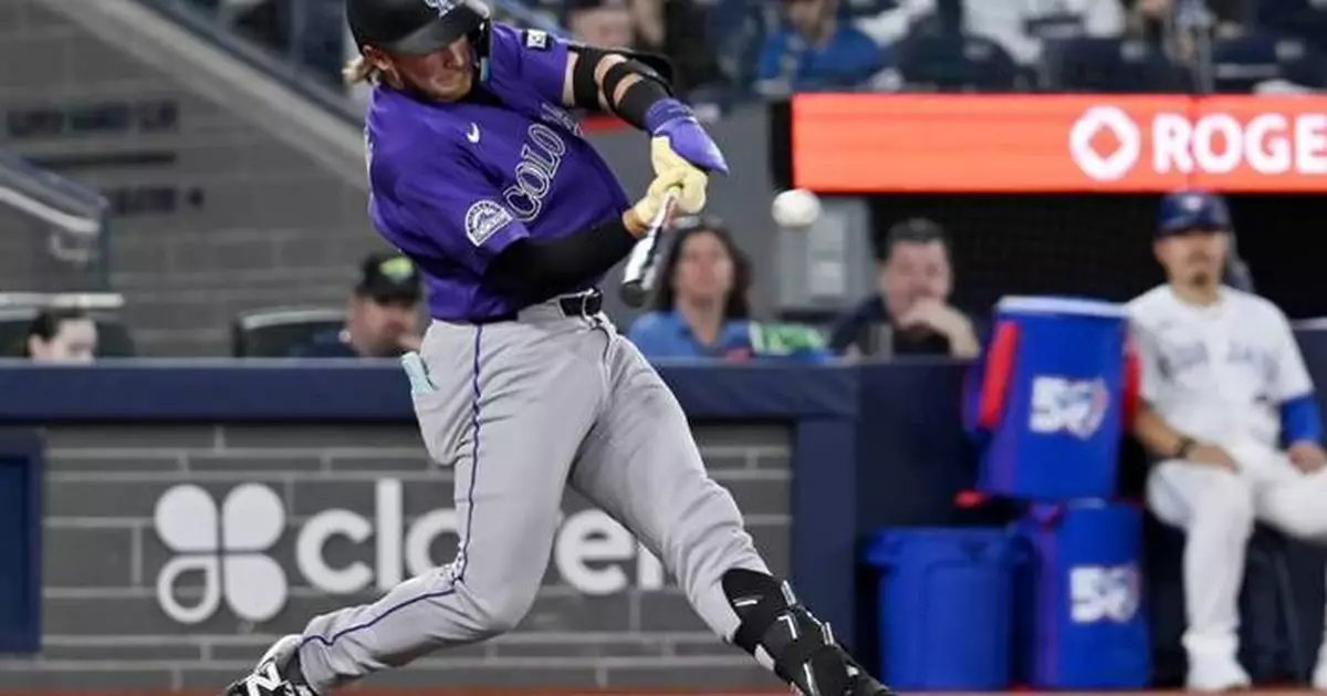 Johnston hits a 2-run homer as the Rockies rout the Blue Jays 14-5 for their 1st win of the season