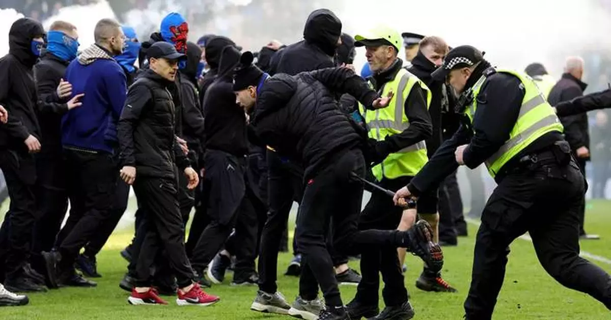 Rangers and Celtic fans clash on the field after Scottish Cup tie