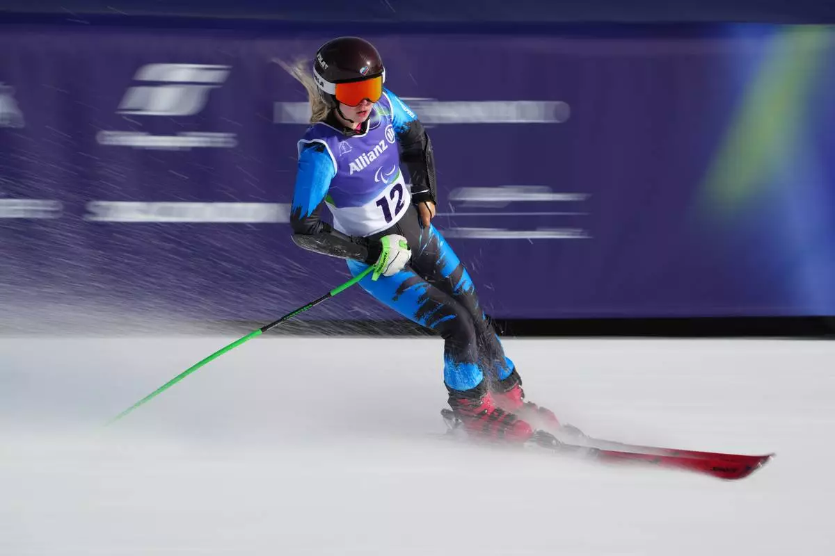 Varvara Voronchikhina, of Russia, crosses the finish line in the alpine skiing women's super-G standing final at the 2026 Winter Paralympics, in Cortina d'Ampezzo, Italy, Monday, March 9, 2026. (AP Photo/Emilio Morenatti)