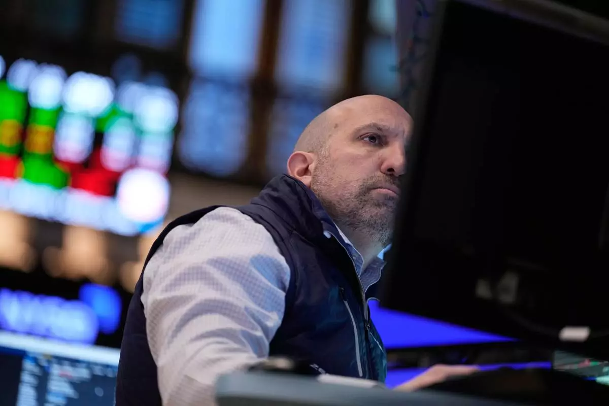 James Denaro works on the floor at the New York Stock Exchange in New York, Monday, March 30, 2026. (AP Photo/Seth Wenig)