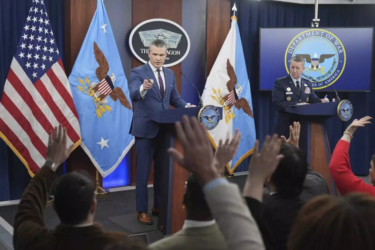 Defense Secretary Pete Hegseth and Chairman of the Joint Chiefs of Staff Gen. Dan Caine take questions during a press briefing at the Pentagon, Monday, March 2, 2026, in Washington. (AP Photo/Mark Schiefelbein)