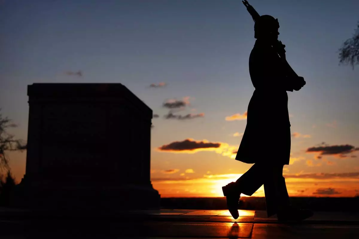 A U.S. Army honor guard member stands vigil at dawn at the Tomb of the Unknown Soldier on Tuesday, March 17, 2026, at Arlington National Cemetery in Arlington, Va., ahead of the 100th anniversary of a continuous honor guard presence at the tomb, celebrated March 25, 2026. (AP Photo/Mark Schiefelbein)